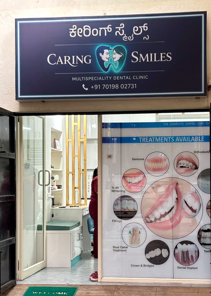 Clinic entrance with the navy signboard and the treatments poster in the window