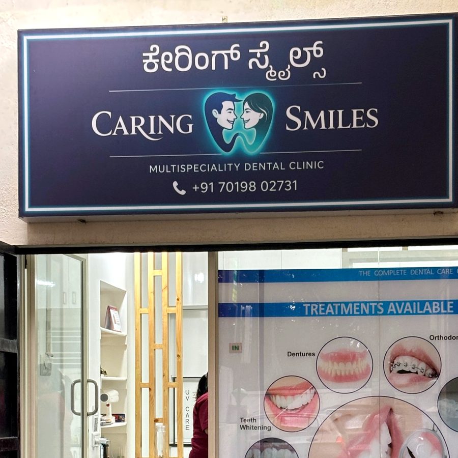 Caring Smiles clinic entrance with its navy signboard